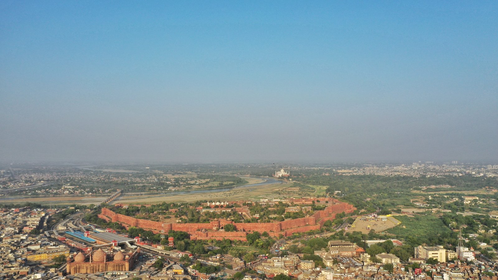 An aerial shot of Agra city with Taj-Mahal on the background
