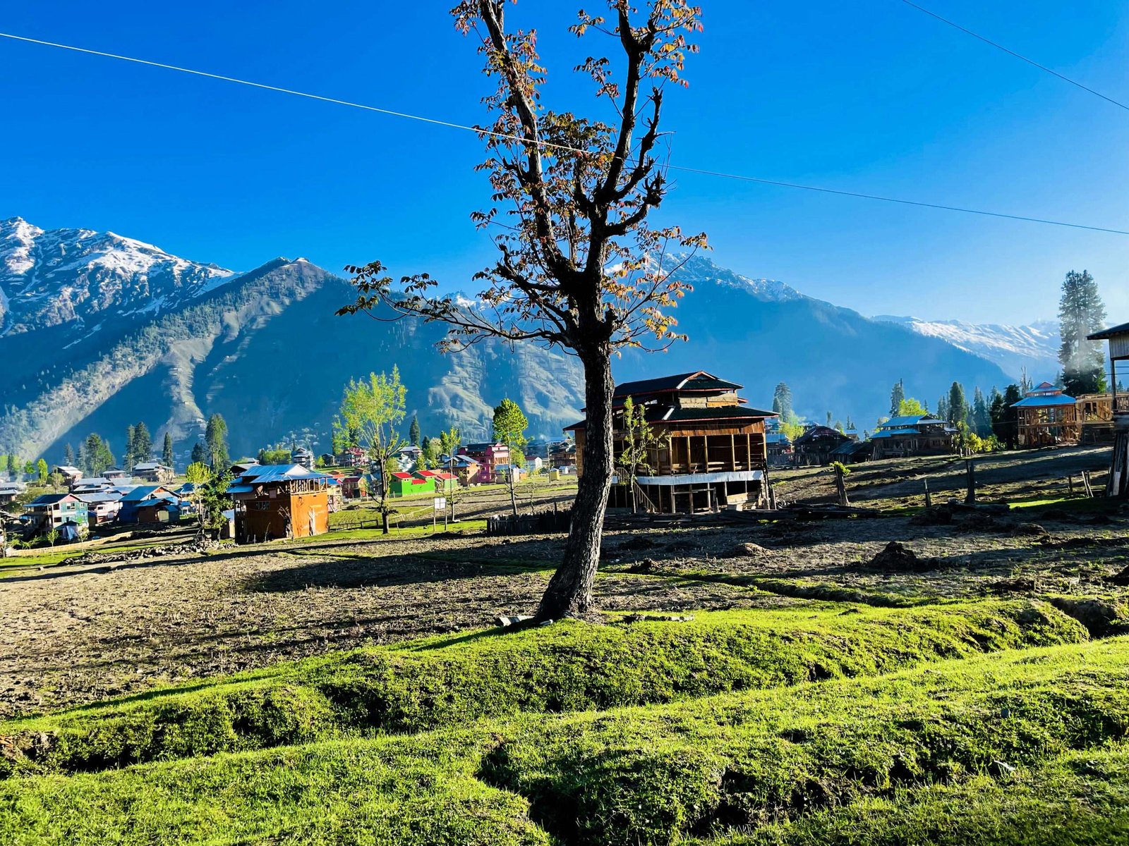 beautiful-landscape-arang-kel-kashmir-with-green-fields-local-houses-with-hidden-clouds