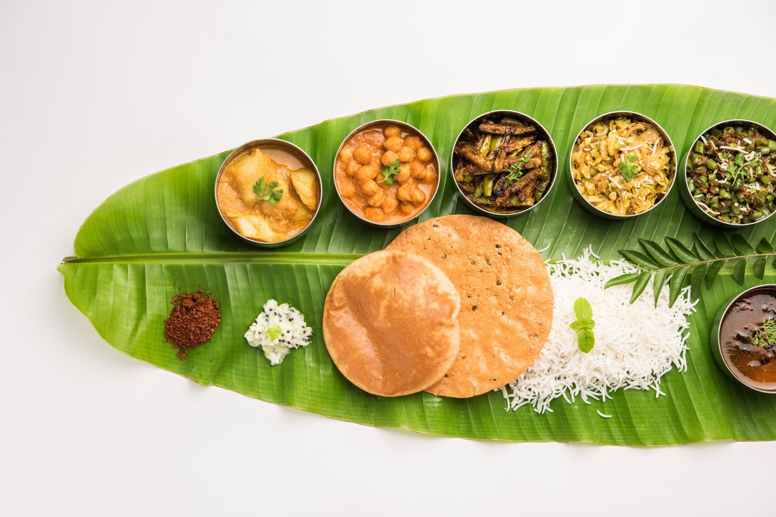 Traditional South Indian Meal or food served on big banana leaf, Food platter or complete thali.  selective focus